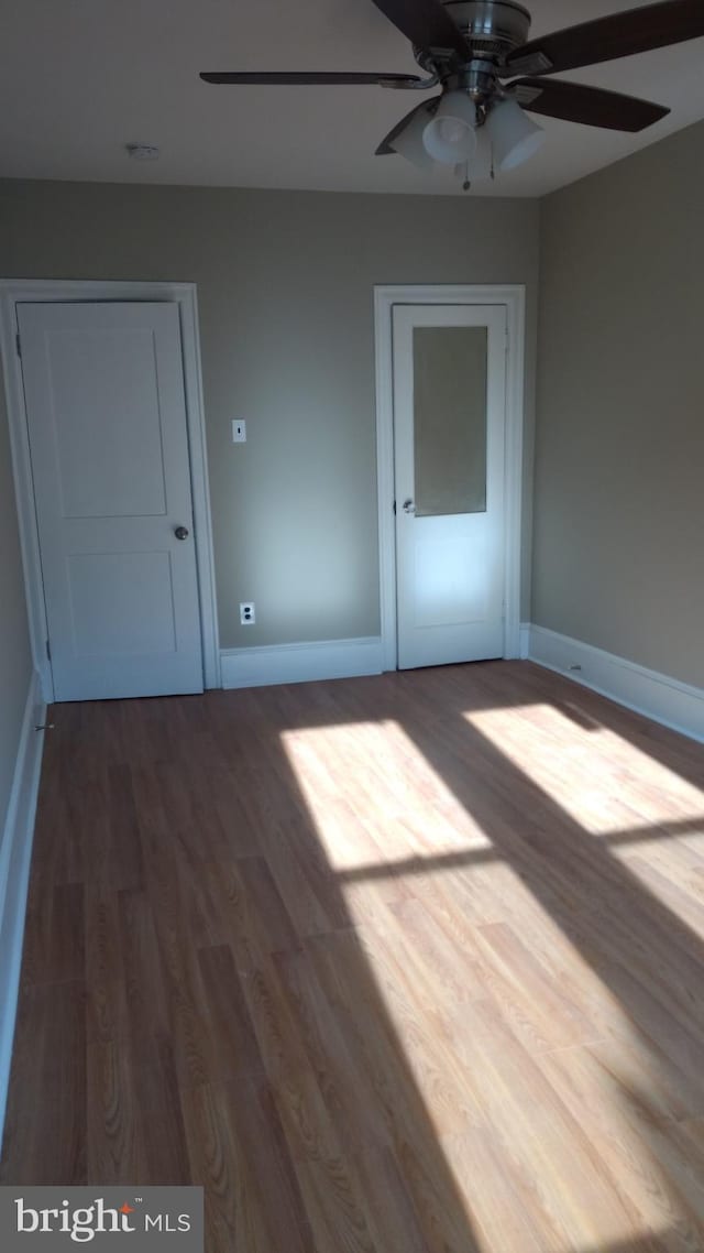 unfurnished bedroom featuring ceiling fan and hardwood / wood-style floors