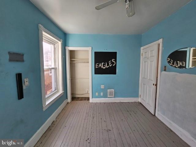 unfurnished bedroom featuring light hardwood / wood-style floors and ceiling fan