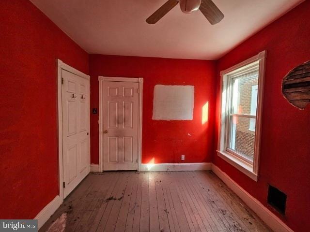 unfurnished room with hardwood / wood-style floors and ceiling fan