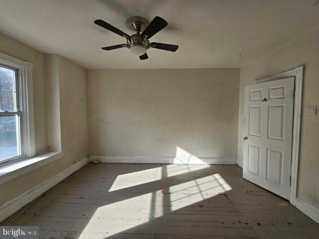 unfurnished room featuring ceiling fan and dark hardwood / wood-style floors