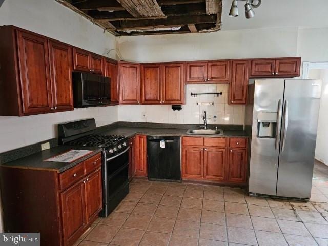 kitchen featuring light tile patterned floors, sink, and black appliances