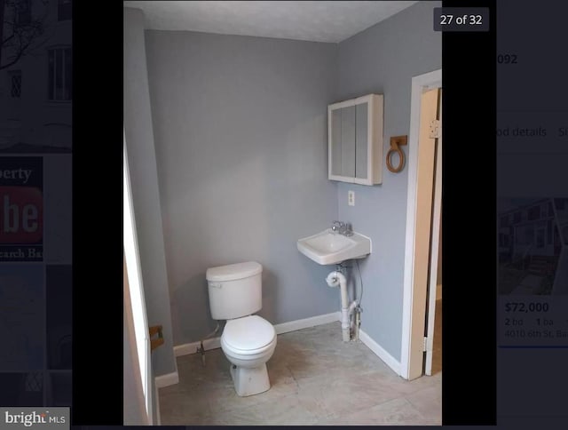 bathroom with toilet and sink