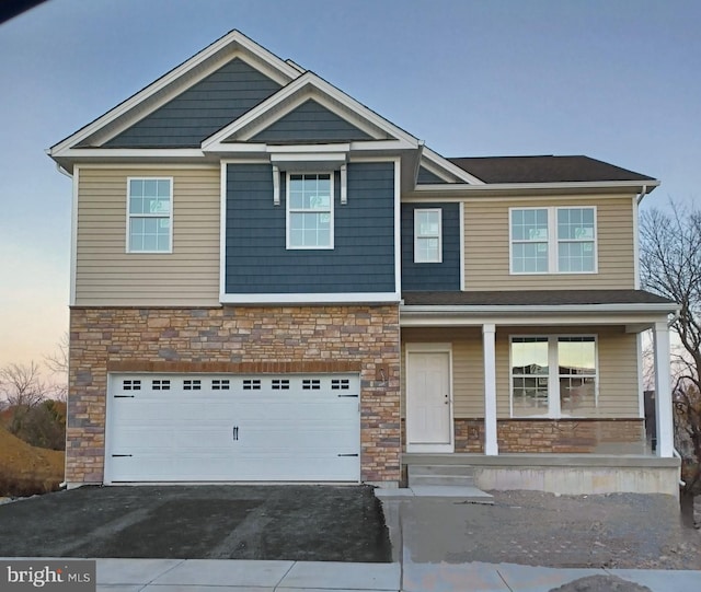 view of front of house with a garage and a porch