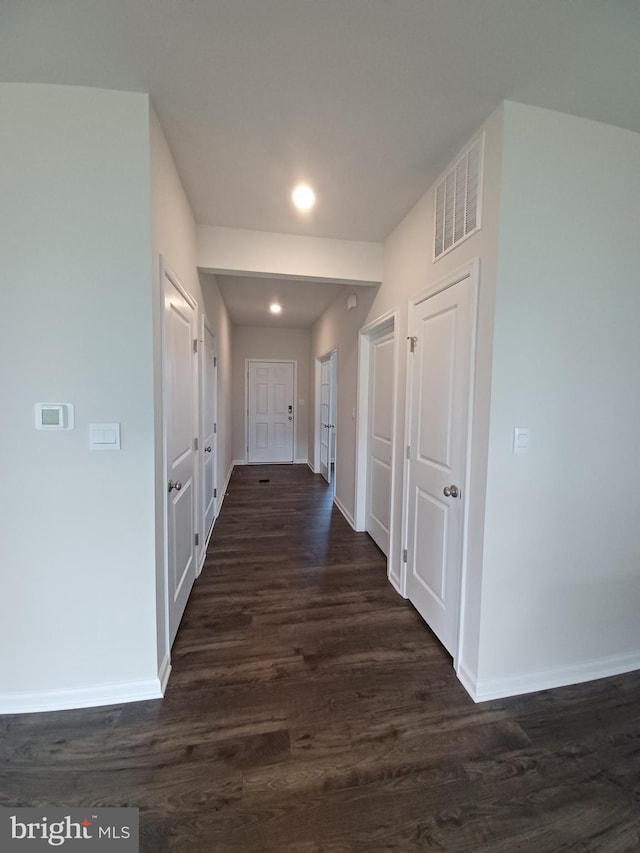 corridor with dark wood-type flooring