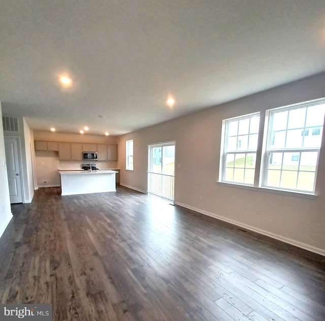 unfurnished living room with dark hardwood / wood-style flooring