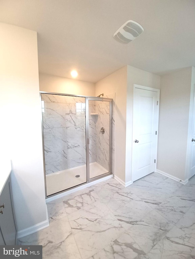 bathroom featuring a shower with shower door