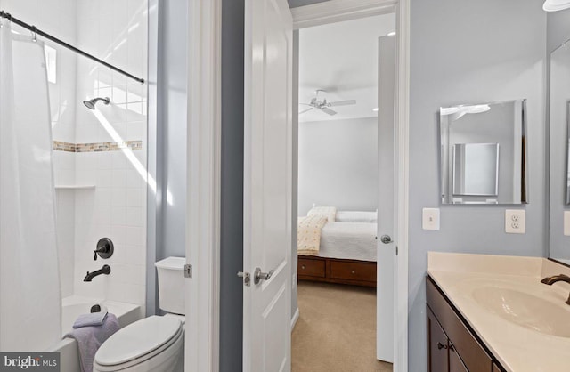 full bathroom featuring tiled shower / bath combo, vanity, ceiling fan, and toilet