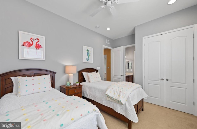 carpeted bedroom with ceiling fan and a closet