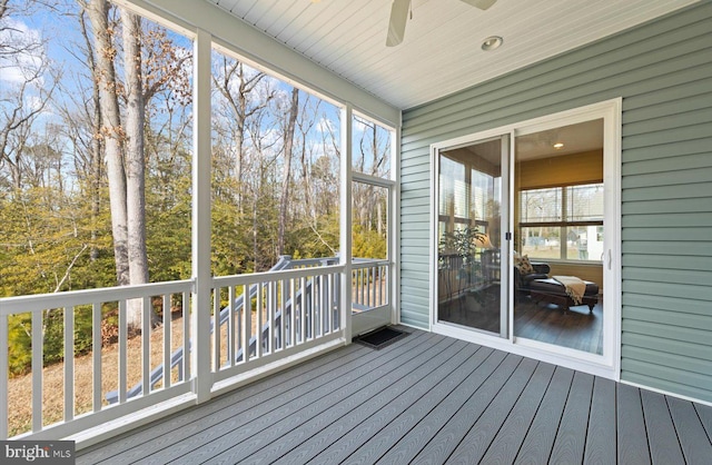 unfurnished sunroom with ceiling fan