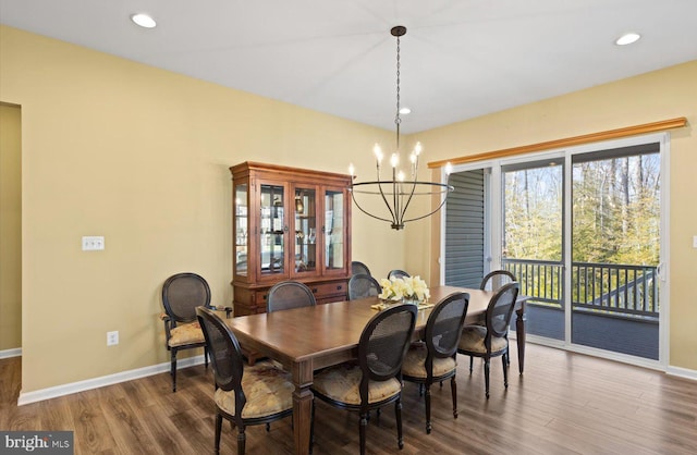 dining room with a notable chandelier and dark hardwood / wood-style floors