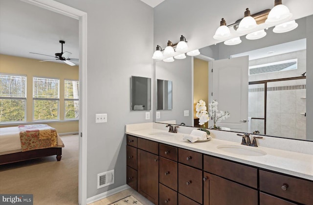 bathroom with ceiling fan, vanity, and a shower