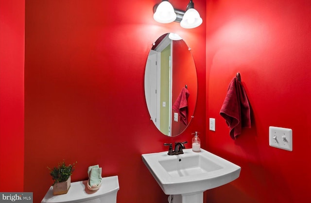 bathroom featuring sink and toilet