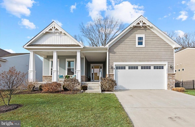 craftsman-style home featuring a porch, a garage, and a front yard