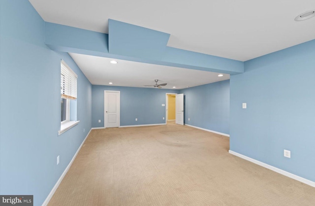 spare room with light colored carpet and ceiling fan