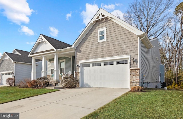 craftsman-style home featuring a porch, a garage, and a front lawn