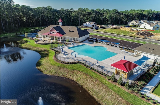 view of pool featuring a patio and a water view