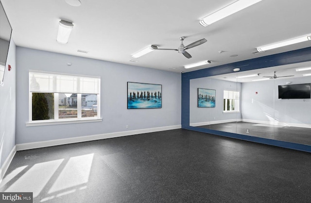 exercise room with ceiling fan