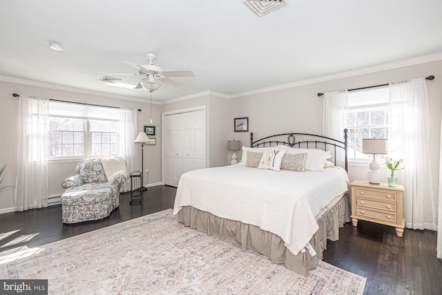 bedroom with multiple windows, ceiling fan, dark hardwood / wood-style flooring, and a closet