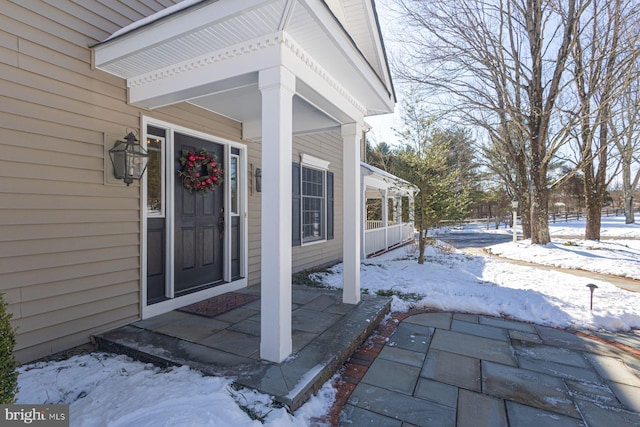 view of snow covered property entrance