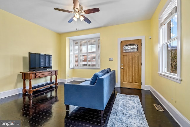 interior space featuring dark wood-type flooring and ceiling fan