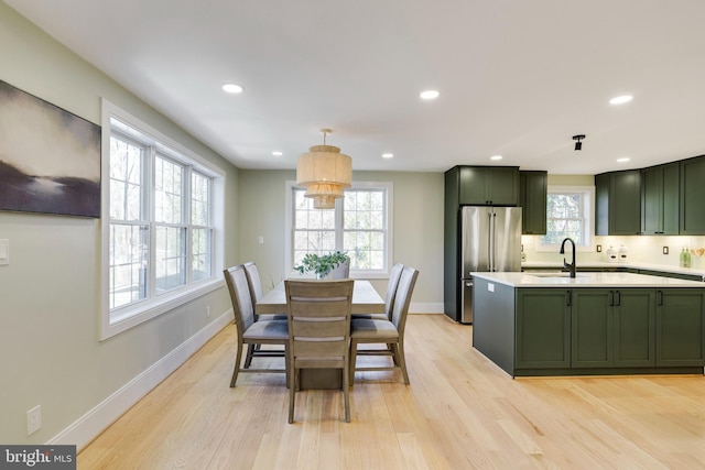 dining room featuring sink and light wood-type flooring