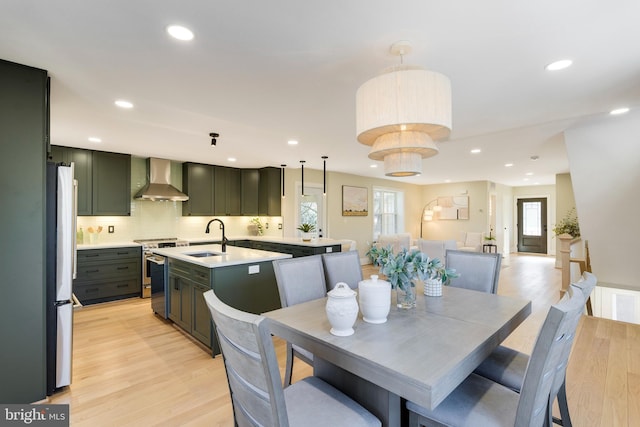 dining room featuring light hardwood / wood-style floors and sink