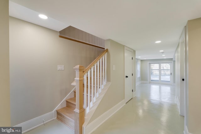 staircase with concrete flooring