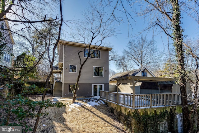 rear view of property with a wooden deck