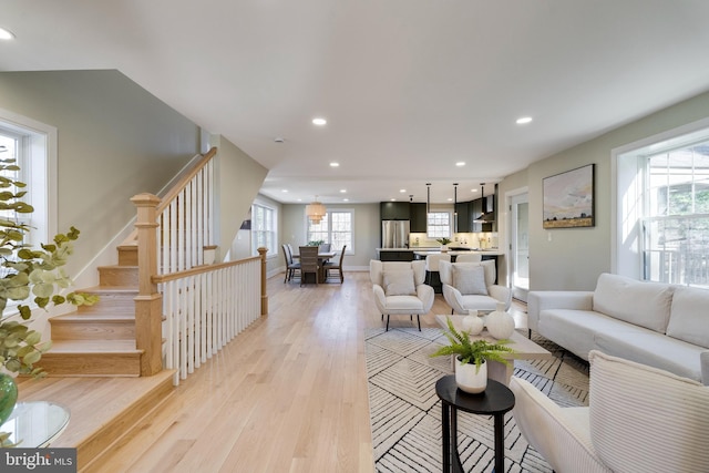 living room featuring plenty of natural light and light hardwood / wood-style floors