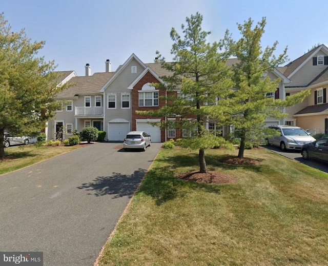 view of front of property with a garage and a front lawn