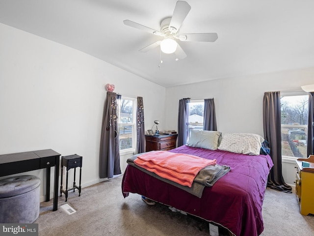 bedroom featuring light carpet and ceiling fan