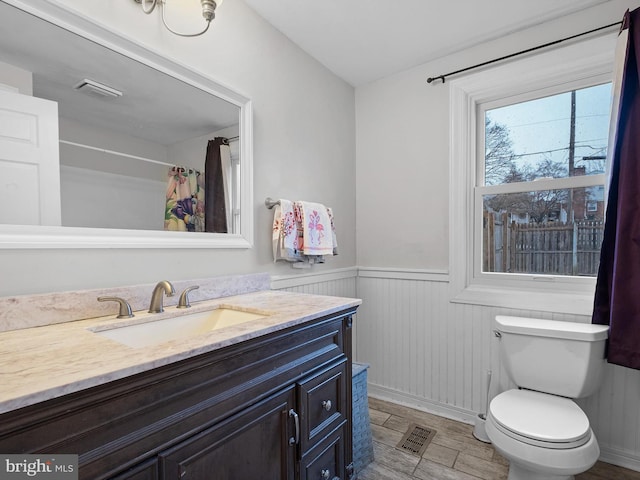 bathroom featuring vanity, toilet, and a shower with shower curtain