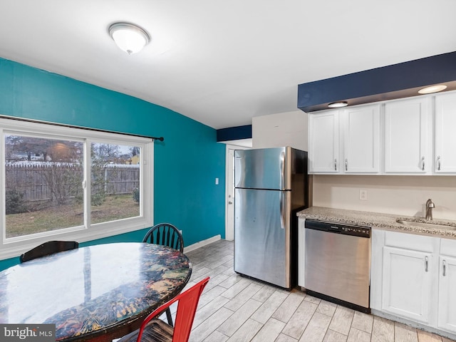 kitchen with white cabinetry, stainless steel appliances, and sink