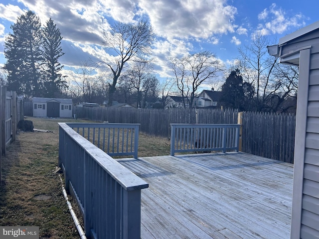 wooden deck with a storage shed