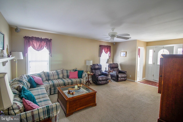 carpeted living room with ceiling fan