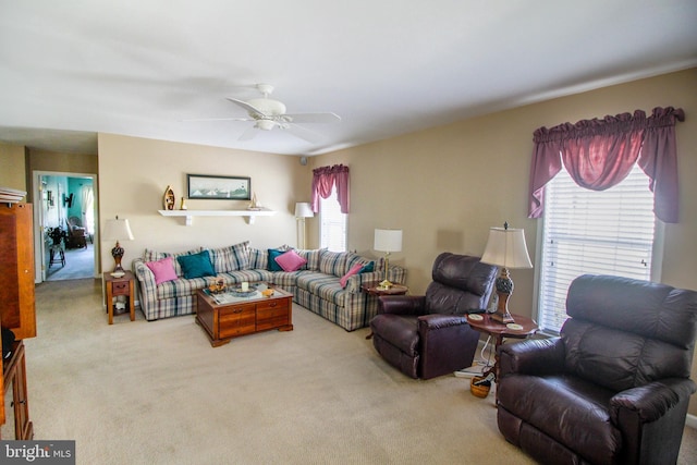 carpeted living room with ceiling fan