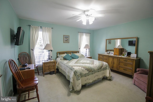 bedroom with light carpet and ceiling fan
