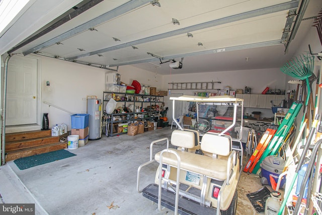 garage with a garage door opener and electric water heater