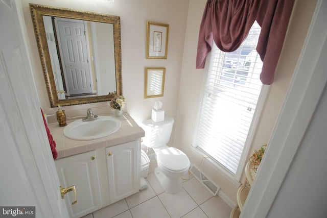 bathroom with vanity, toilet, and tile patterned flooring
