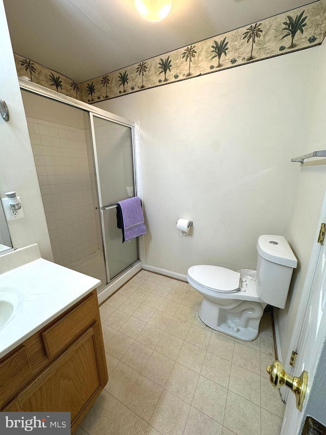 bathroom featuring vanity, toilet, and an enclosed shower