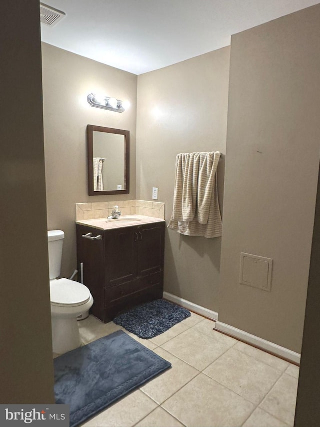 bathroom featuring tile patterned floors, toilet, and vanity