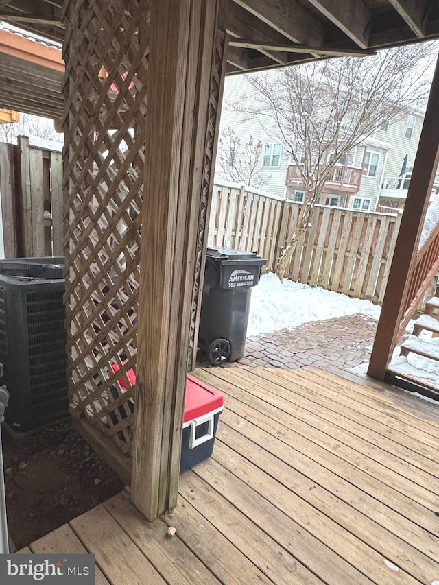 snow covered deck featuring central AC unit