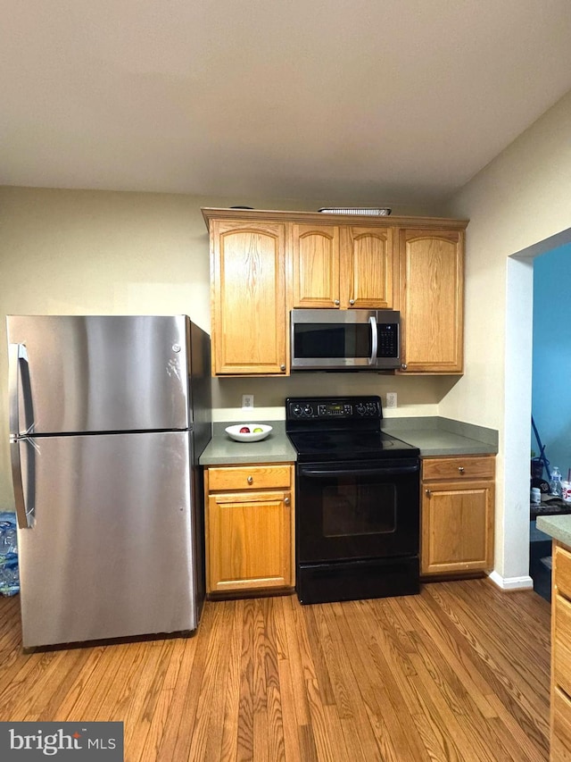 kitchen with appliances with stainless steel finishes and light wood-type flooring