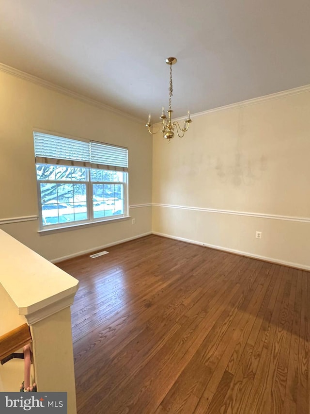 interior space featuring crown molding, dark hardwood / wood-style floors, and an inviting chandelier