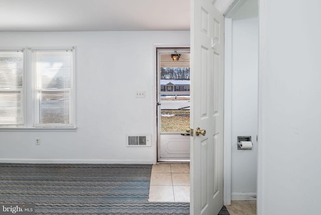 interior space featuring tile patterned flooring and plenty of natural light