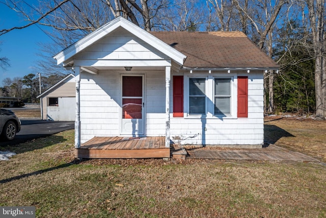 bungalow-style house with a garage and a front yard