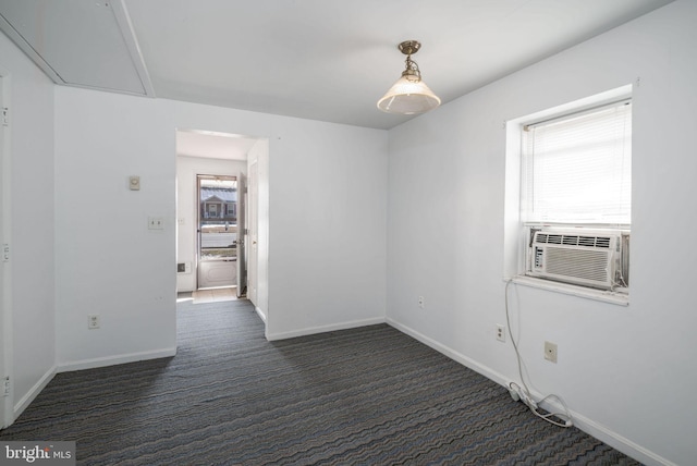 spare room with cooling unit and dark carpet