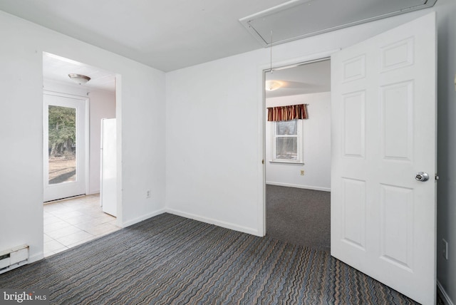 carpeted spare room featuring a baseboard radiator