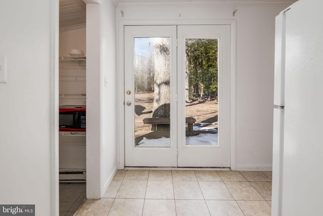 doorway with light tile patterned floors and baseboard heating