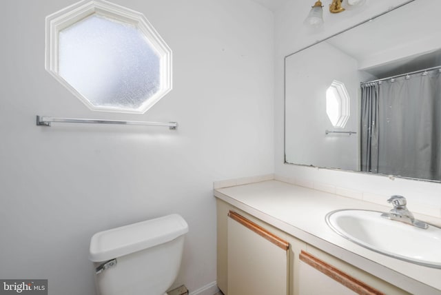 bathroom with vanity, toilet, and a shower with shower curtain